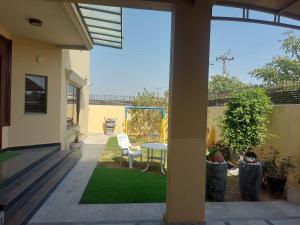 a patio with a table and chairs in a yard at Urban Villa in Islamabad