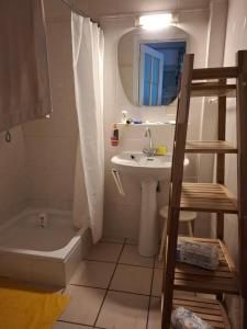 a bathroom with a sink and a tub and a toilet at Apartment Descamps in Blankenberge +30 photos