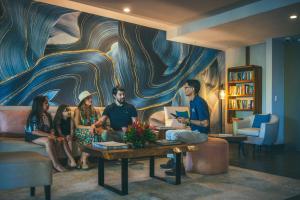 a group of people sitting on a couch in a living room at Los Altos Resort in Manuel Antonio +97 photos