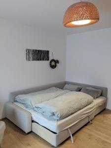 a bed in the corner of a room with a lamp at Apartment L i e b l i n g s o r t in Golling an der Salzach