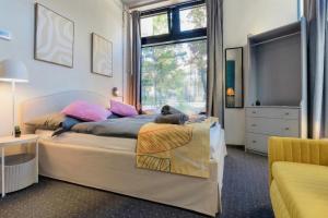 a bedroom with a bed with a cat laying on it at UrbanKey Studios - Vienna Mitte in Vienna
