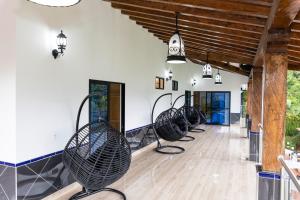 a row of chairs lined up in a room at Ecohotel Dubai del Oriente in El Peñol