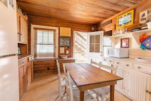 a kitchen with a wooden table and a wooden ceiling at 5441 - Rascoe in Nags Head