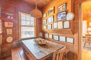 a dining room with a wooden table with a bowl of food at 5441 - Rascoe in Nags Head +38 photos