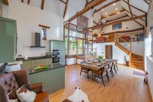 a kitchen and dining room with a table and chairs at Hillside Barn in Gimingham