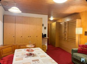 a room with a table and a couch and a kitchen at Soldanella Cervinia apartment Vda Vacanze in Vetta CIR 0253 in Breuil-Cervinia