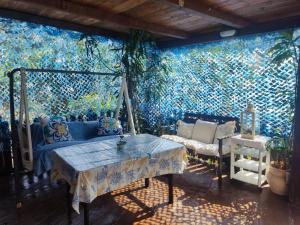 a room with a table and a wall with a mural at La Sorgente Apartment with private pool in Calice Ligure