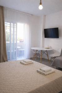 a bedroom with a bed with two towels on it at Kristina Stelios Apartment in Platanias