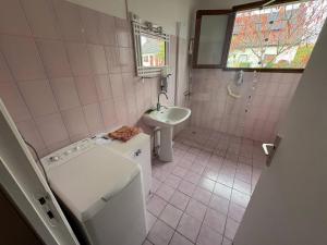 a bathroom with a sink and a washing machine at Le Petit Puits de l Ange in Bonny-sur-Loire +7 photos