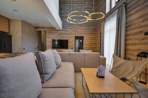 a living room with a couch and a table at Golden Chalet in Bukovel