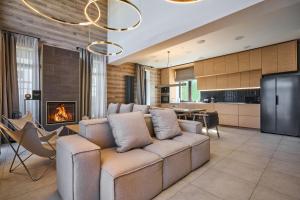 a living room with a couch and a fireplace at Golden Chalet in Bukovel