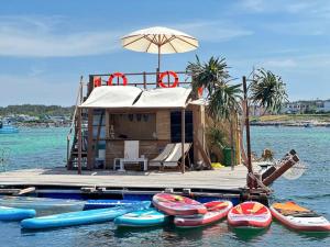 a house on a dock with boats on the water at Villa - Homestay Giác in Cu Lao Thu