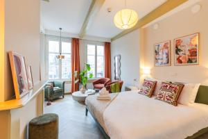 a bedroom with a bed and a living room at Brass Hotel in Utrecht