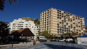 a large apartment building in the middle of a street at Apartamentos Chinasolymar in Almuñécar