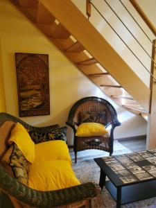 a living room with two chairs and a table at La Maison d'Eana in Maintenon