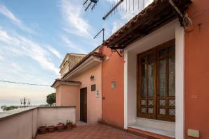 a building with a wooden door and a balcony at A casa di Gennarino in Cetara +11 photos