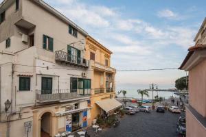 an apartment building with cars parked in a parking lot at A casa di Gennarino in Cetara