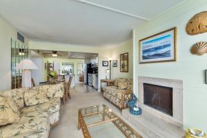 a living room with a couch and a fireplace at 5695 - Pelican's Perch in Nags Head