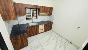 an overhead view of a kitchen with wood and marble counters at MIRACLE inn NEAR AL-AMEEN COLLEGE in Alwaye +24 photos
