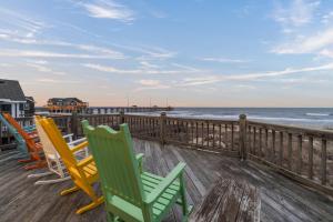 a deck with chairs and a view of the ocean at 5725 - A Dream Vacation in Nags Head