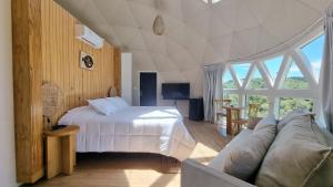 a bedroom with a bed and a couch in a room at Sierra Pacífica in Minas +61 photos
