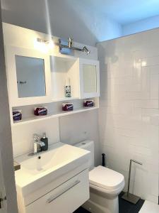 a white bathroom with a sink and a toilet at Brightridge Condos in Bridgetown +25 photos