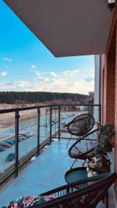 a balcony with two chairs and a view of a parking lot at No 59 Apartament in Nowy Targ