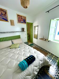 a bedroom with a large white bed in a room at Surf house in Essaouira