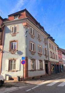 a white building on the side of a street at Logement atypique en souplex in Sélestat