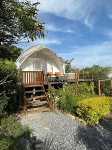 a large dome tent with a porch in a garden at Origen Glamping en Villa de Leyva in Villa de Leyva