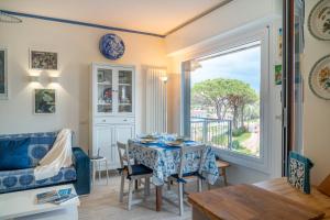 a living room with a table and a window at Casa Concetta in Rapallo