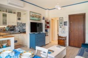 a kitchen with a blue cabinet and a table at Casa Concetta in Rapallo