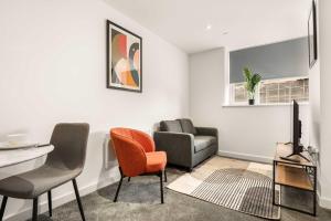 a living room with a couch and a table and chairs at Stylish 1 BED Apartment in Central Hull in Hull