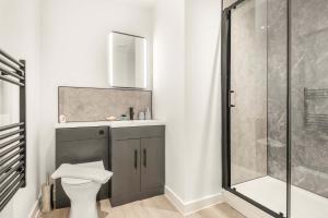 a bathroom with a shower and a toilet and a sink at Stylish 1 BED Apartment in Central Hull in Hull