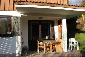 a patio with a table and chairs on a porch at Ferienhaus Alpkönigin in Missen-Wilhams