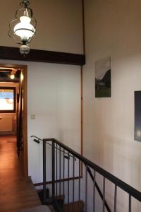 a hallway with a staircase and a chandelier at Ferienhaus Alpkönigin in Missen-Wilhams