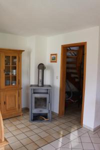 a living room with a stove and a door at Ferienhaus Alpkönigin in Missen-Wilhams