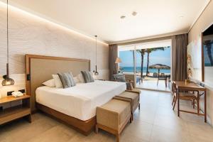 a hotel room with a bed and a balcony with the ocean at Punta Sal Suites & Bungalows Resort in Canoas de Punta Sal +89 photos