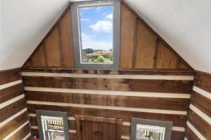 a window in a room with wooden walls at Rustic Mountain Escape with Fire Pit and Mountain Views-Cabin 1 in Fancy Gap