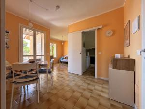 a kitchen and dining room with a table and a dining room at Capo d 'Arco - Agrumeto in Capo D'Arco