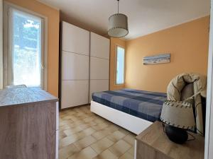 a bedroom with a bed and a chair in it at Capo d 'Arco - Agrumeto in Capo D'Arco +12 photos
