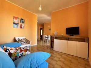 a living room with a couch and a flat screen tv at Capo d 'Arco - Agrumeto in Capo D'Arco