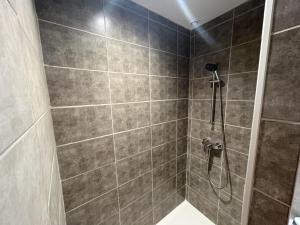 a bathroom with a shower with a shower head at Le Mercoyrol in Cruas