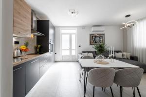a kitchen and living room with a table and chairs at Cozy Corner 49 in Cavtat
