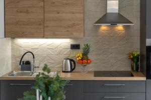 a kitchen with a sink and a counter with fruit at Cozy Corner 49 in Cavtat +54 photos