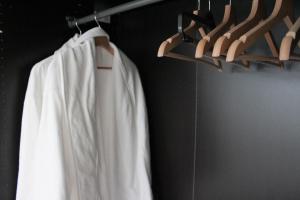 a white shirt and hangers in a room at Apartmán Relax so saunou a jakuzzi in Námestovo +18 photos