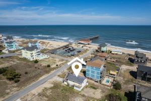 an aerial view of a city and the ocean at 7039 - A Wave From It All in Rodanthe