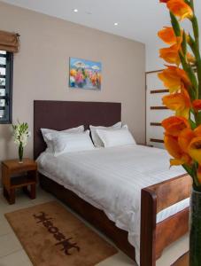 Postel nebo postele na pokoji v ubytování Plumeria Hotel