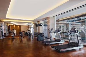 a gym with several treadmills and elliptical machines at MORAZEN Surabaya in Surabaya