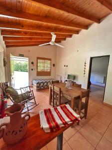 a living room with a wooden table and a couch at Caty in Merlo